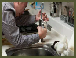 plumber fixing sink faucet